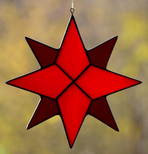 Suncatcher " Star ",eight-pointed,stained glass,tiffany technique,red,light orange,opalescent,dark red,transparent,diameter ca. 13 cm,item number 30040A,manufactured in our own atelier.Carmen Harusta,Glasinsel ®,Göttingen,Germany.