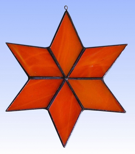 Fensterbild " Stern ",stained glass,orange,opalescent,diameter ca. 13 cm,item number 30074E,manufactured in our own atelier.Carmen Harusta,Glasinsel ®,Goettingen,Germany.