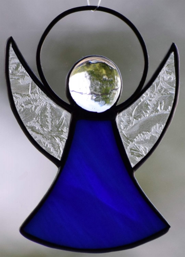 Guardian Angel,stained glass;dress: dark blue,white,opalescent;wings: glue chip glass,clear;head: glass nugget,clear,size ca. 7 x 5 cm,manufactured in our own atelier,item number 30060B.Carmen Harusta,Glasinsel ®,Goettingen,Germany.