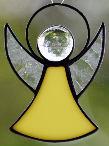 Guardian Angel,stained glass;dress: light yellow,opalescent;wings: glue chip glass,clear;head: glass nugget,clear,size ca. 7 x 5 cm,manufactured in our own atelier,item number 30060K.Carmen Harusta,Glasinsel ®,Goettingen,Germany.
