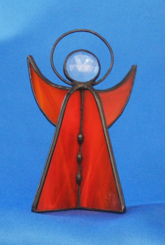 Standing angel,stained glass,orange,semi transparent,with faceted glass stone,clear,height ca. 9,5 cm,item number 30039F,manufactured in our own atelier.Carmen Harusta,Glasinsel ®,Goettingen,Germeny (front view).