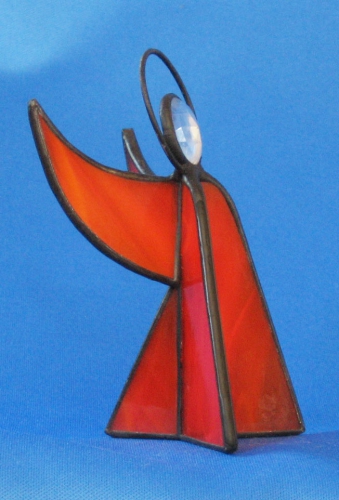 Standing angel,stained glass,orange,semi transparent,with faceted glass stone,clear,height ca. 9,5 cm,item number 30039F,manufactured in our own atelier.Carmen Harusta,Glasinsel ®,Goettingen,Germeny (side view).
